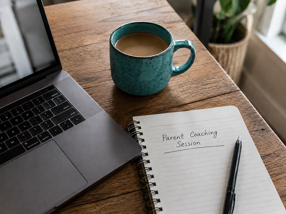 Parent coaching session setup - laptop, notebook and coffee